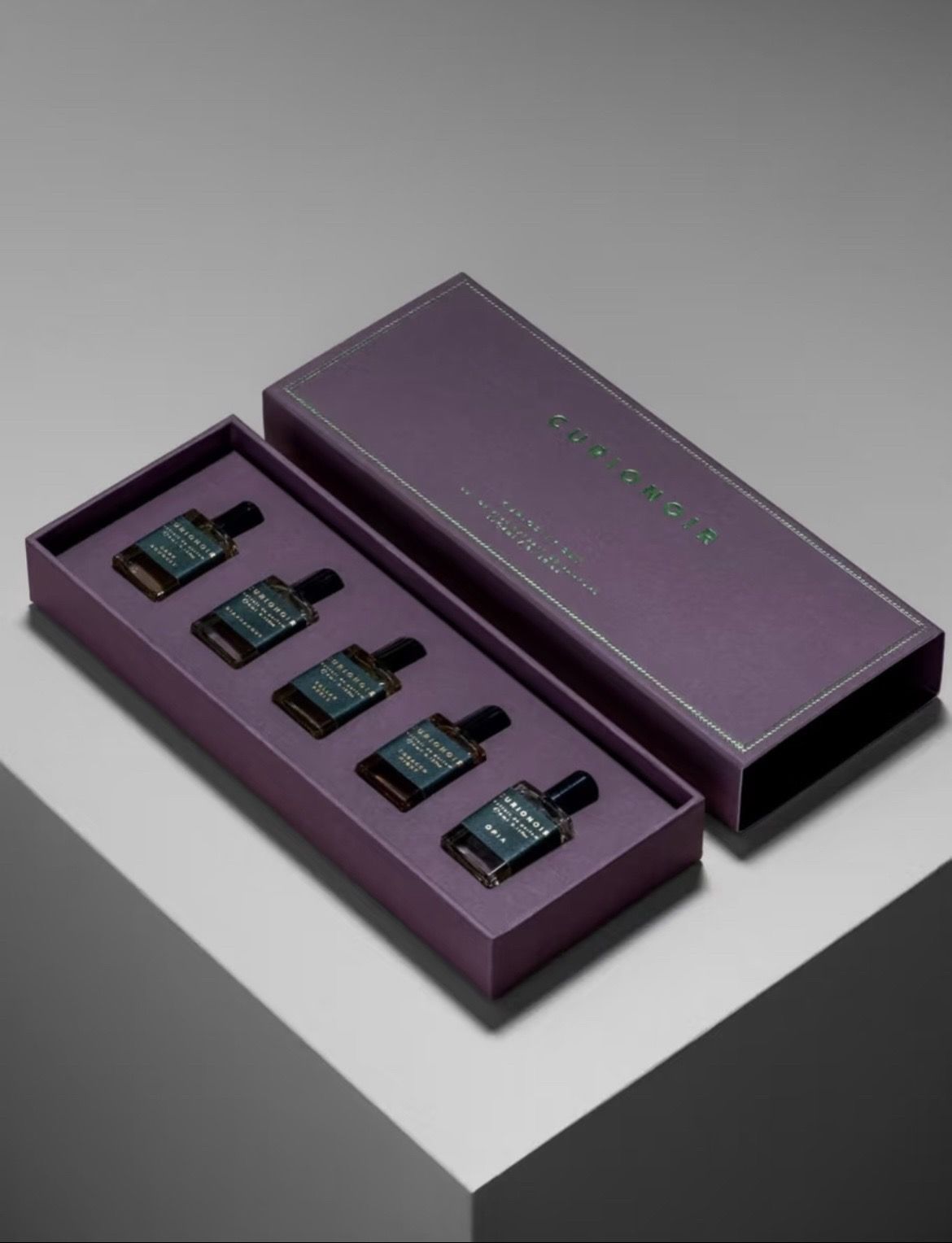 Purple drawer gift box holding five small bottles