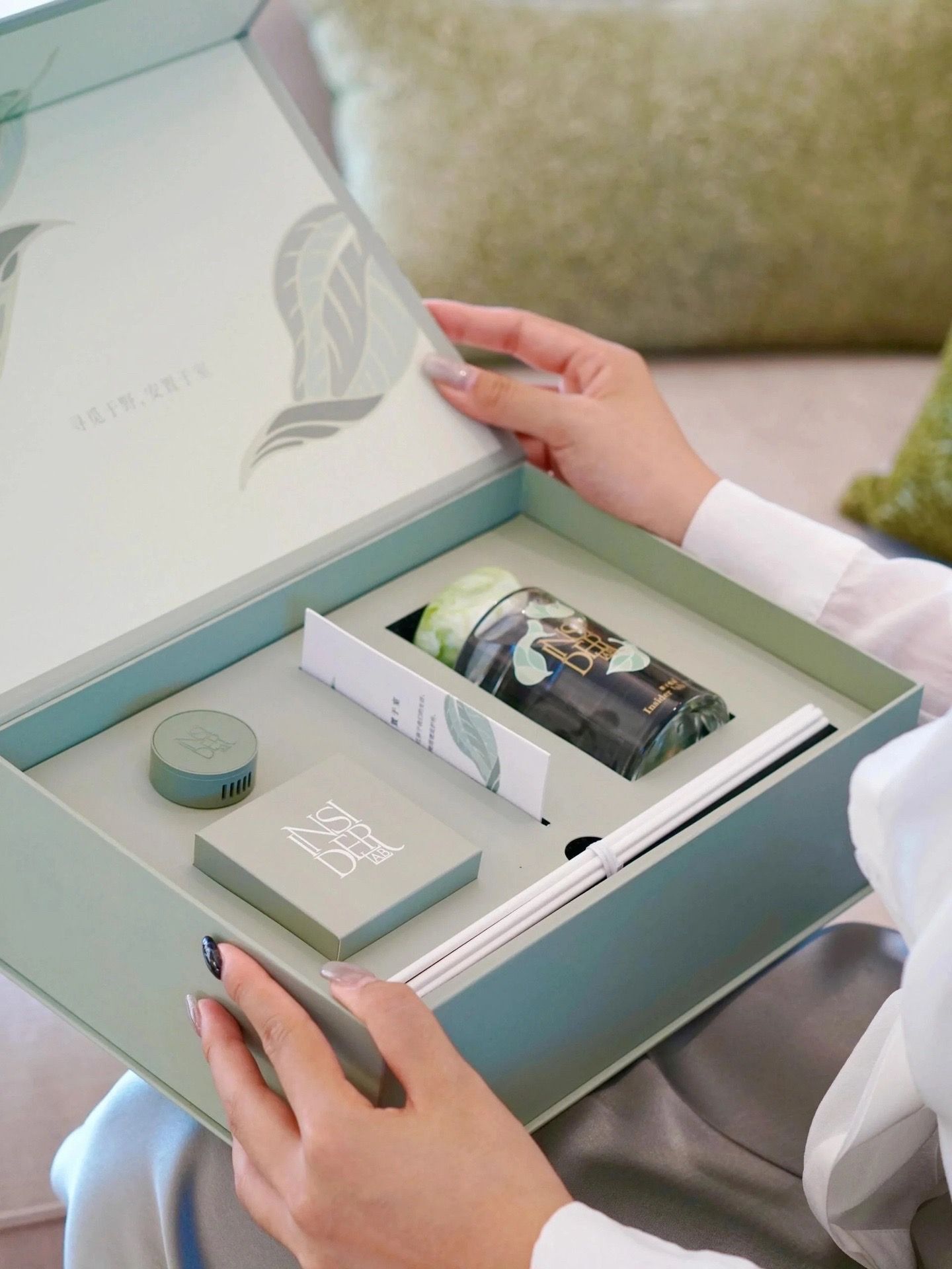 Sage green wellness gift box with a fitted multi-item insert